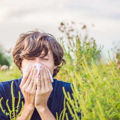 Boy sneezes because of an allergy about to get naturopathy treatment