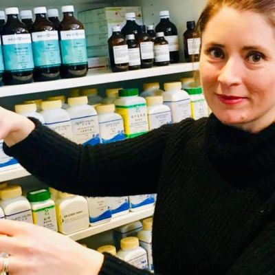 Our Practitioner Sallie pouring herbs to make Naturopathic Meds